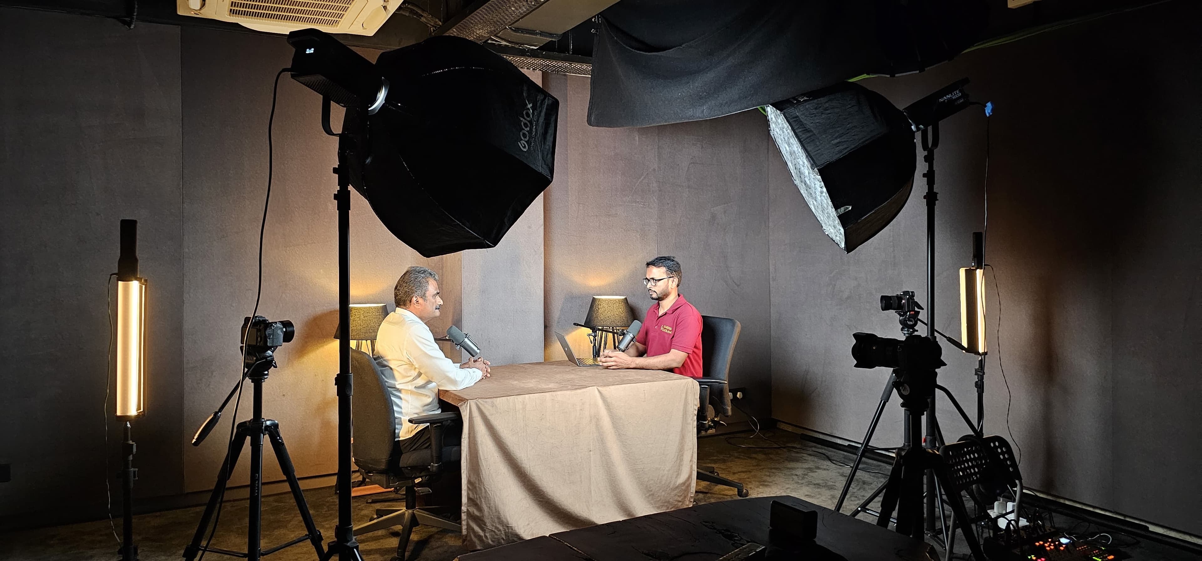 The recording setup — Harish and a guest mid-conversation in the studio